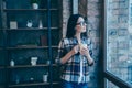 Portrait of her she nice cute lovely attractive charming sweet brunette lady wearing checked shirt looking at window at Royalty Free Stock Photo