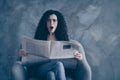 Portrait of her she nice-looking attractive lovely cute worried shocked wavy-haired girl sitting in chair reading digest Royalty Free Stock Photo