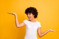 Portrait of her she nice lovely attractive cheerful glad crazy optimistic wavy-haired girl holding two palms copy empty