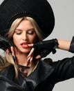 Portrait of High fashion glamour beautiful blonde hair russian woman in modern hat in black leather gloves Royalty Free Stock Photo