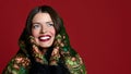 Portrait of High fashion glamour beautiful brunette hair Russian style woman in traditional scarf and gloves on red Royalty Free Stock Photo