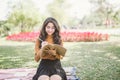 Portrait of high school girl thinking and read a book in park, education reading book and thinking creative idea concept Royalty Free Stock Photo