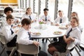 Portrait Of High School Students Wearing Uniform Sitting Around Table And Eating Lunch In Cafeteria Royalty Free Stock Photo