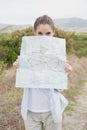 Portrait of a hiking young woman holding map