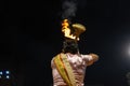 Portrait of hindu male priest performing ganga aarti in varanasi