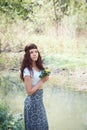 Portrait of hippie girl in forest with flowers Royalty Free Stock Photo