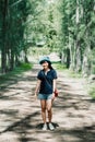 Portrait of of Hipster asian woman stands alone with pine tree and enjoying a beautiful nature Royalty Free Stock Photo