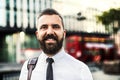 A portrait of hipster businessman standing on the street in London. Royalty Free Stock Photo