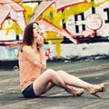 A portrait of a hipster girl blowing bubbles on the roof.