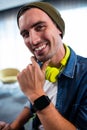 Portrait of hipster man smiling at camera while working at computer desk Royalty Free Stock Photo