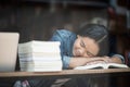 Portrait of hipster teenage sleeping on table at cafe looks tired