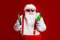 Portrait of his he attractive cheerful cheery funny fat white-haired Santa holding in hand beer bottles invite festal
