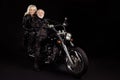 Portrait of his he her she nice attractive lovely cool free cheerful grey-haired rockers driving harley davidson chopper Royalty Free Stock Photo