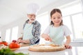 Portrait of his he her she nice cheerful focused grey-haired granddad grandchild cooking preparing flavoring fresh