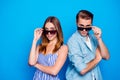 Portrait of his he her she two nice attractive trendy lovely content people partners wearing touching sun specs looking Royalty Free Stock Photo