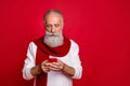 Portrait of his he nice attractive calm concentrated gray-haired man holding in hands device gadget chatting 