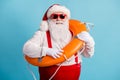 Portrait of his he nice attractive cheerful cheery confident white-haired Santa swimmer sailor wearing safe life buoy