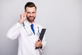 Portrait of his he nice attractive cheerful cheery doc physician holding in hand document clipboard touching specs first Royalty Free Stock Photo