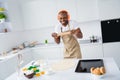 Portrait of his he nice attractive cheerful cheery foolish childish comic funky guy making handmade pie cake using pin