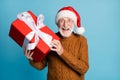 Portrait of his he nice attractive cheerful cheery glad elderly bearded grey-haired Santa father holding in hands big