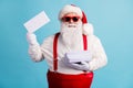 Portrait of his he nice attractive cheerful confident white-haired Santa father holding in hand pile mail letters wish