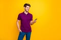 Portrait of his he nice attractive content cheerful cheery glad guy wearing violet shirt using gadget sharing repost smm