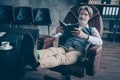 Portrait of his he nice attractive handsome confident focused gray-haired gentleman sitting in chair reading scientific Royalty Free Stock Photo