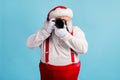 Portrait of his he nice attractive white-haired Santa holding in hands professional camera shooting taking making photo