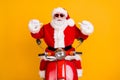 Portrait of his he nice confident cheerful Santa riding moped pointing at himself St Nicholas December tradition