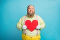 Portrait of his he nice funny glad cheerful cheery man cupid holding in hands big large heart healthcare isolated over Royalty Free Stock Photo