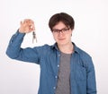 Portrait of his he nice-looking attractive content guy wearing blue shirt holding in hand showing keys
