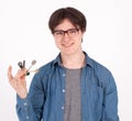 Portrait of his he nice-looking attractive content guy wearing blue shirt holding in hand showing keys