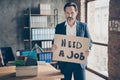 Portrait of his he serious jobless guy realtor economist holding in hands placard saying need a job find solution at