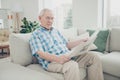 Portrait of his he single nice focused concentrated peaceful calm granddad sitting on divan reading world news paper in