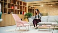 Portrait of Hispanic Creative Young Woman Working on a Laptop in Casual Office. Female Team Lead Royalty Free Stock Photo