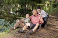 Portrait Hispanic father and sons outdoors by pond