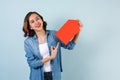 Portrait of hispanic girl smiling looking at camera  and pointing finger to copy space blank card on blue background in Mexico Lat Royalty Free Stock Photo