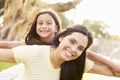 Portrait Of Hispanic Mother And Daughter In Park