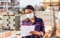 Portrait of woman worker in mask standing with note list at warehouse