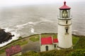 Portrait of the historic Heceta head lighthouse on a foggy day.