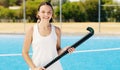 Portrait, hockey girl and field with smile, focus or vision at outdoor training for future sports career. Happy gen z