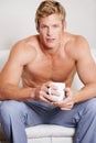 Portrait, home and man with coffee, couch and relax with peace, carefree and morning tea in a lounge. Face, guy and