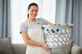 Portrait, home and woman with a laundry basket, smile and cleaning with chores, housekeeping and maid. Face, female