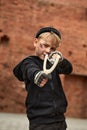 Portrait of homeless street child boy takes aim with a slingshot Royalty Free Stock Photo