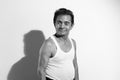 Portrait of a homely asian senior man smiling at the camera, black and white photo concept Royalty Free Stock Photo