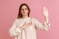 Woman standing with promise hand sign, gesturing palm up, giving promise, pledging allegiance Royalty Free Stock Photo
