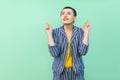 Portrait of hopeful handsome beautiful short hair young stylish woman in casual striped suit standing, crossed fingers and wishful