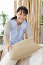 portrait housekeeper tidying sofa