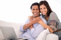 Portrait, hug and couple on sofa with laptop for internet, browse and search for movie subscription. Relax, happy woman Royalty Free Stock Photo