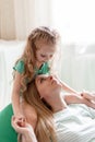 Portrait of hugging mother and daughter. Baby child kid 5 years and mom 30 s look at each other.Maternal Parenting love Royalty Free Stock Photo